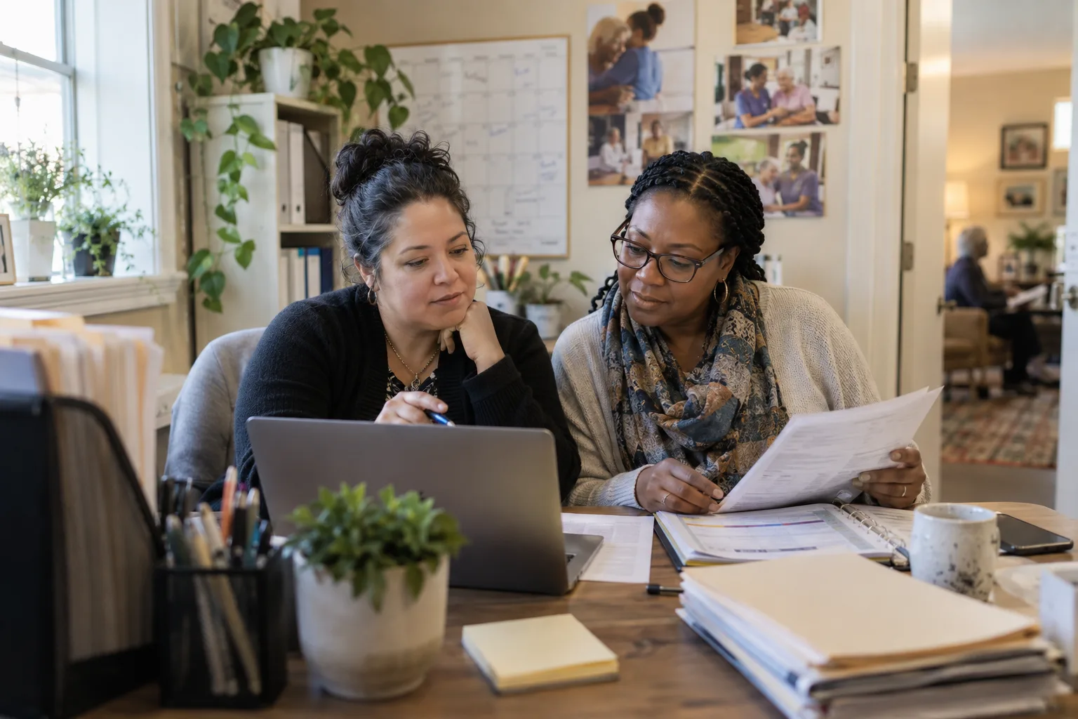 Two home care coordinators reviewing caregiver candidates together