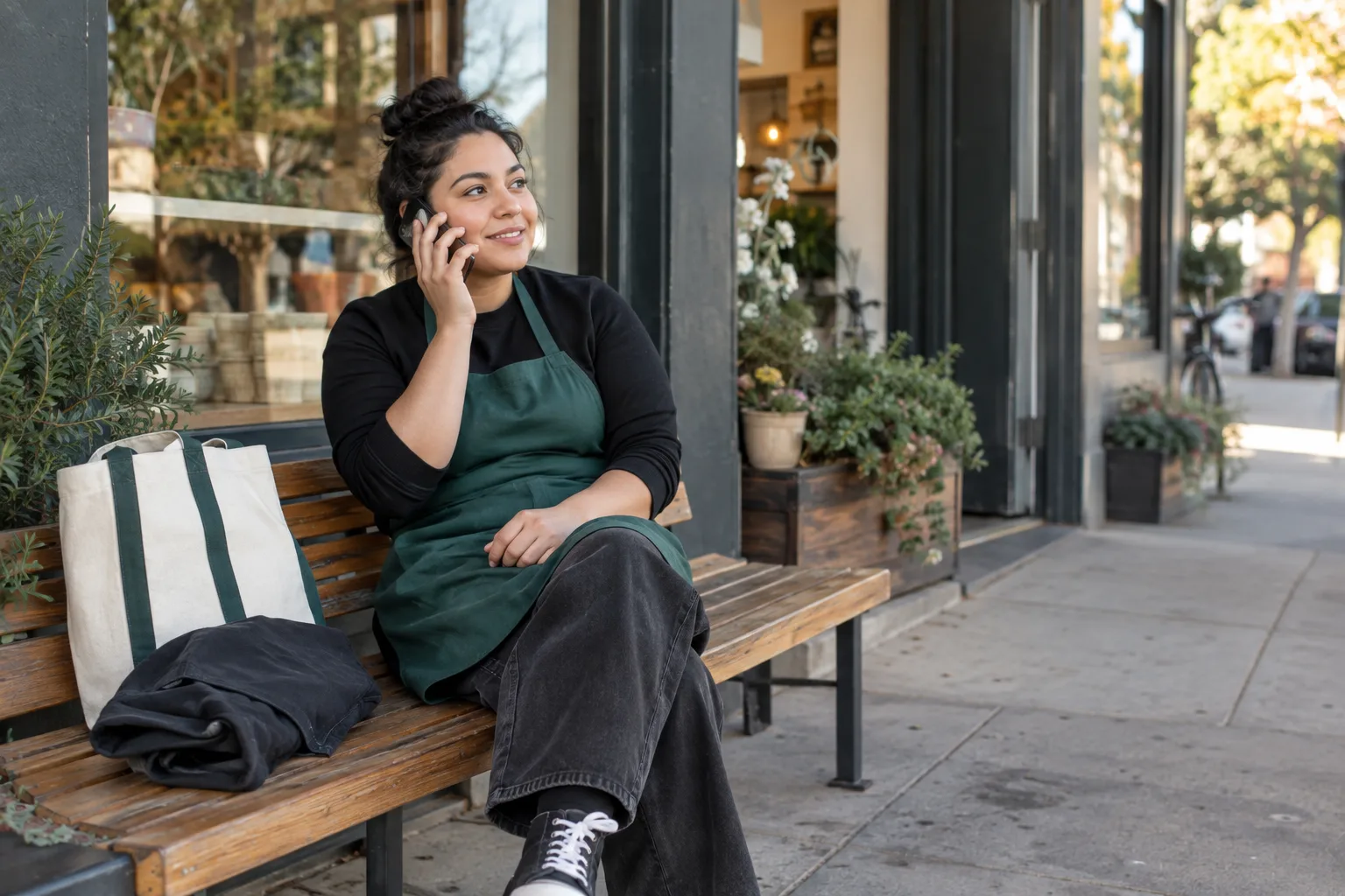 A retail associate taking a phone screen outside a store before opening